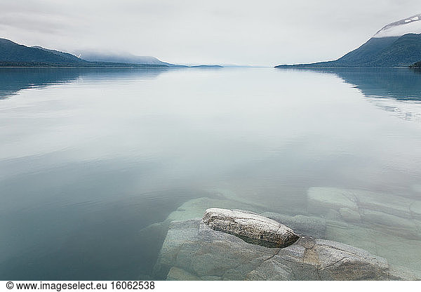 Overcast sky above calm waters of an inlet in a national park.