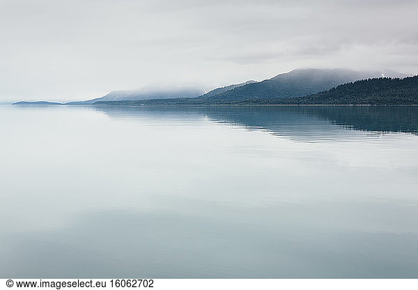 Overcast sky above calm waters of an inlet in a national park.