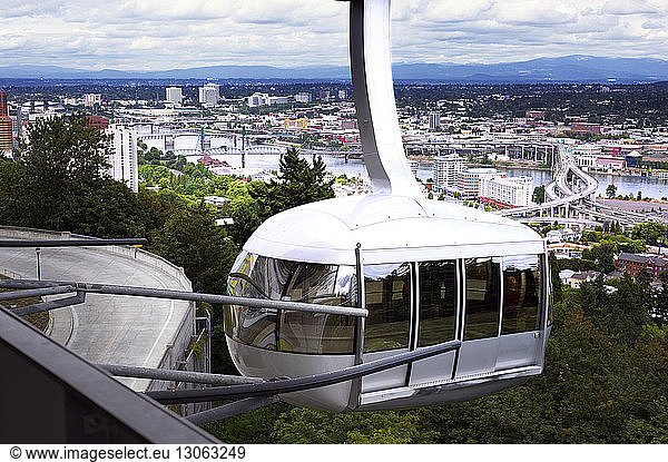 Overhead cable car against cityscape