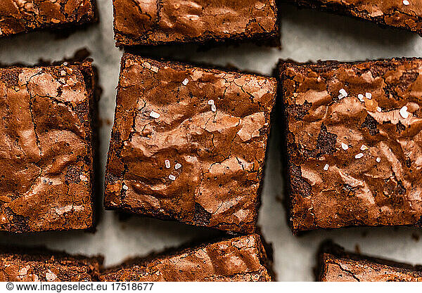 Overhead close up of salted chocolate brownies cut into squares.