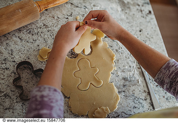 overhead of girl with gingerbread cookie cutout