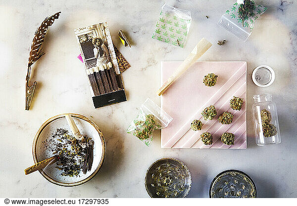 overhead of Wedding Cake cannabis flowers and burning joint