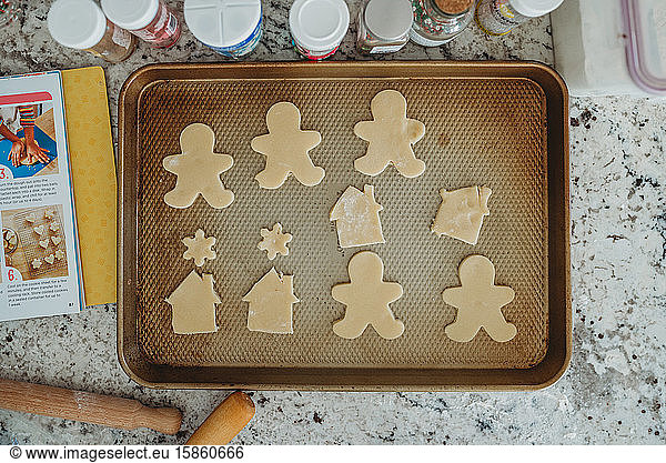 overhead shot of cut out cookies on a baking sheet