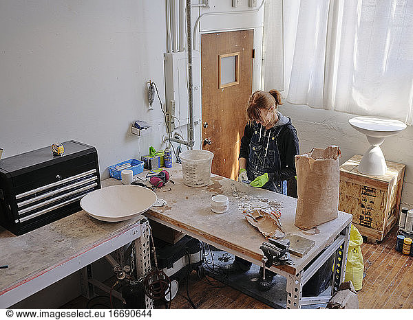 Overhead shot of professional female sculptor working in her studio