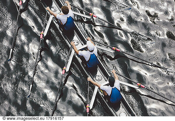 Overhead view of a crew rowing in an octuple racing shell boat  rowers  motion blur.