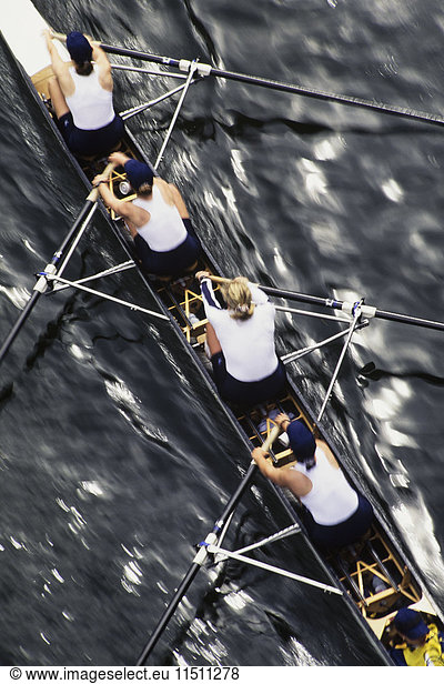 Overhead view of a female rowing crew in their racing shell  rowing boat.