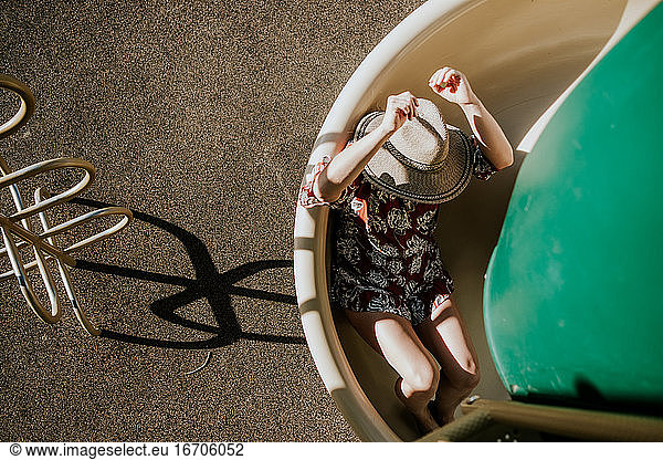 overhead view of a woman sliding down a spiral slide