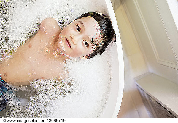 Overhead view of boy bathing at home