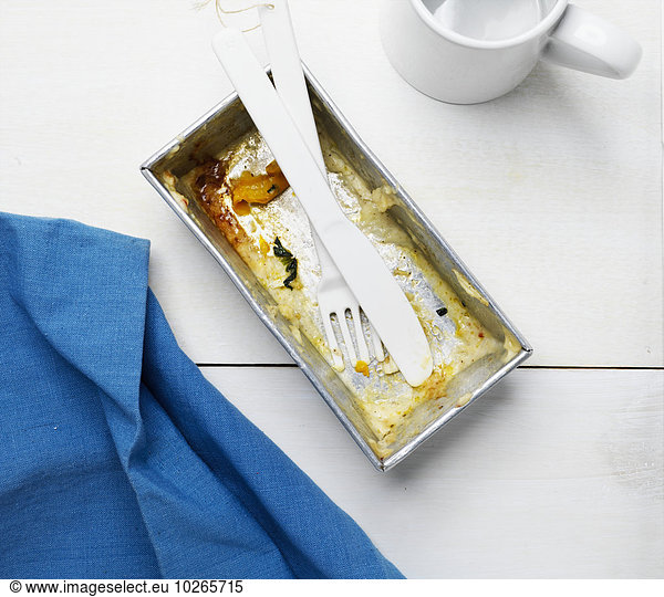 Overhead View of Empty Lasagne Container with Cutlery  Studio Shot