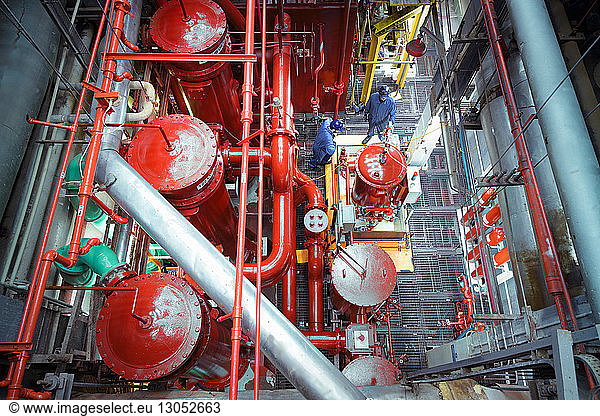 Overhead view of engineers in turbine hall of nuclear power station