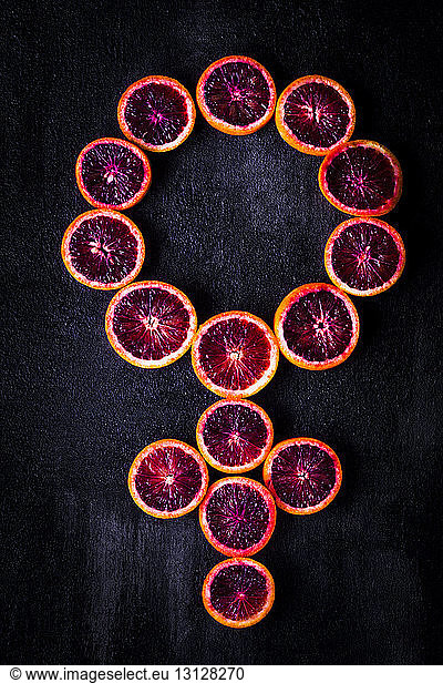 Overhead view of female symbol made with blood oranges on table