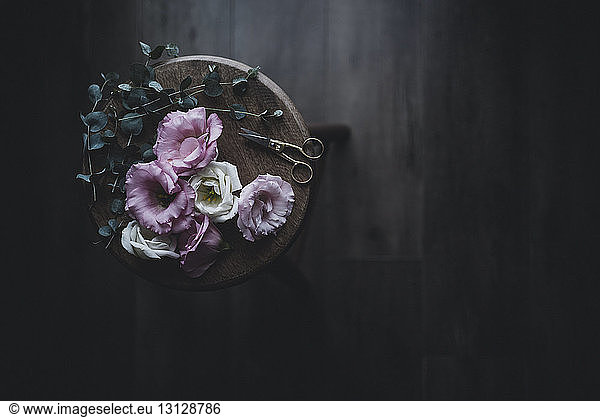 Overhead view of flowers on wooden stool