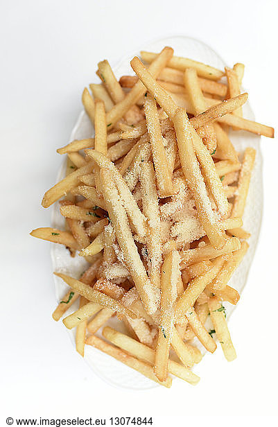 Overhead view of French fries in plate on white background
