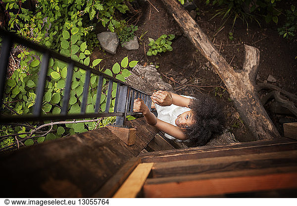 Overhead view of girl climbing on ladder