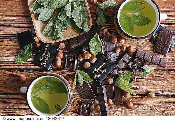 Overhead view of green tea and chocolate on table