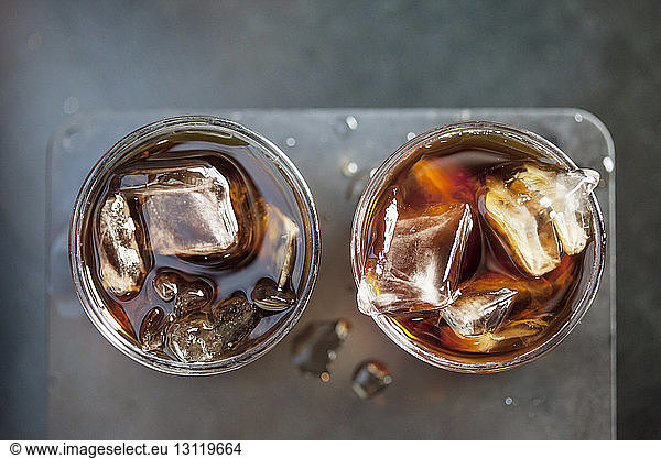 Overhead view of iced coffee in drinking glasses at cafe