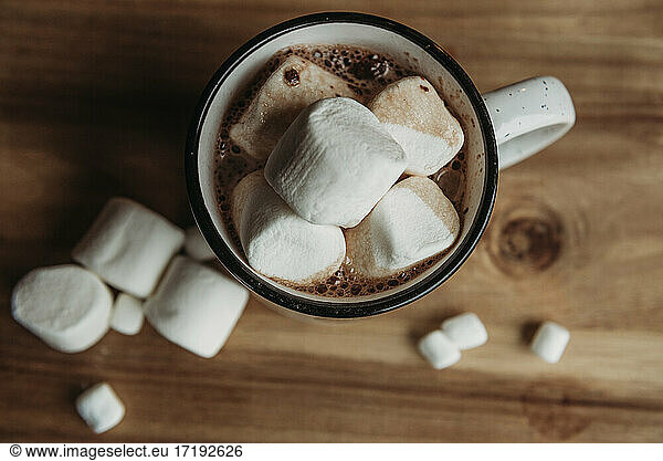 Overhead view of mug filled with hot chocolate and marshmallows