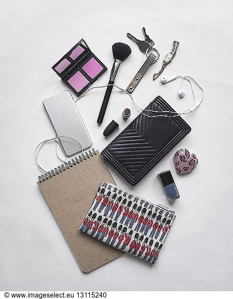 Overhead view of personal accessories on white background