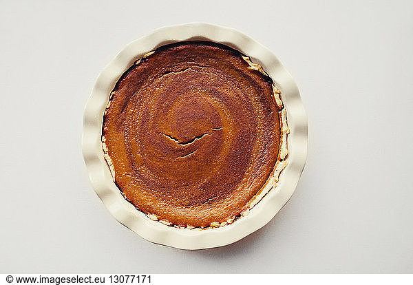 Overhead view of pie served in plate on white table