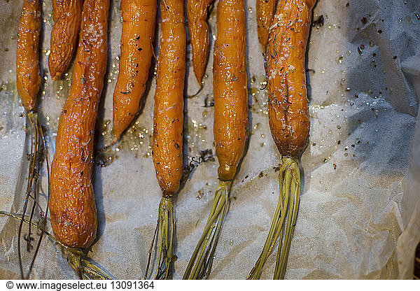 Overhead view of roasted carrots on tissue paper