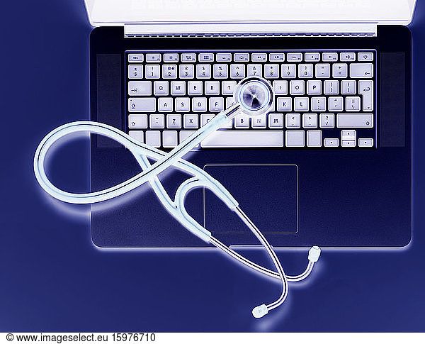 Overhead view of stethoscope on laptop