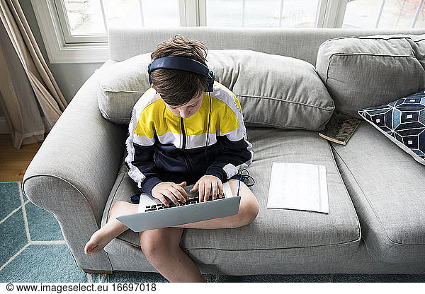 Overhead View of Tween Boy Using Laptop for Distance Learning