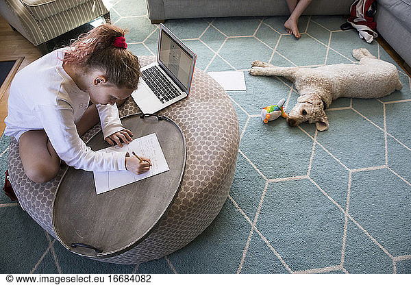 Overhead View of Young Girl Doing Distance Learning on Laptop Computer