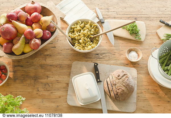 Overhead view pasta  fruit and bread on dining table
