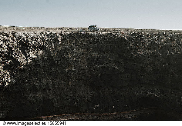 Overland adventure while driving a 4x4 close to the cliff