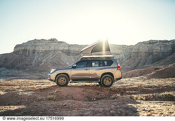 Overland vehicle in the desert at sunrise