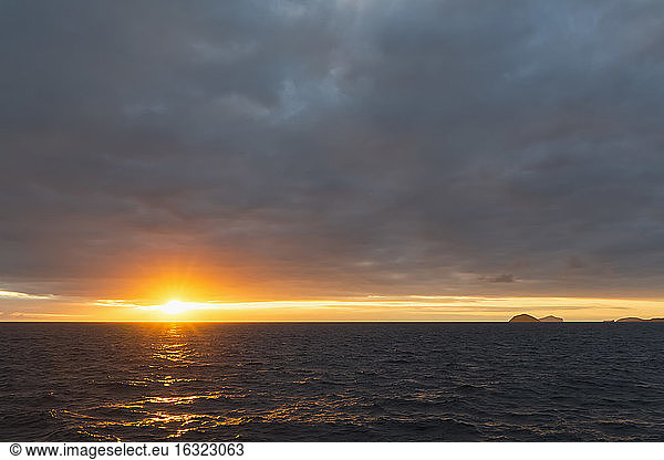 Pacific Ocean  Galapagos Islands  sunrise above island Floreana