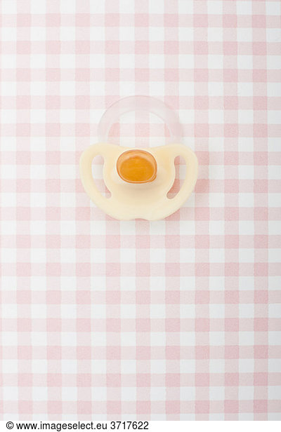 Pacifier on pink checker pattern