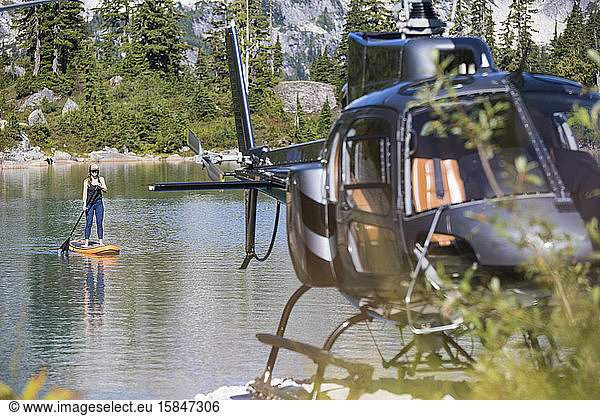 Paddelbretter für Frauen auf einem abgelegenen See  zu denen ein Hubschrauber Zugang hat.