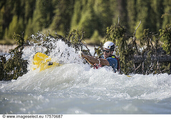 Paddler is engulfed by large rapids  wave.