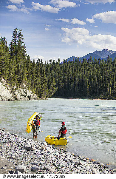 Paddlers stop at the edge of a scenic river  B.C. Canada.