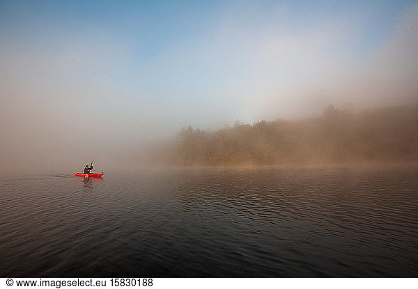 Paddling on a misty pond.