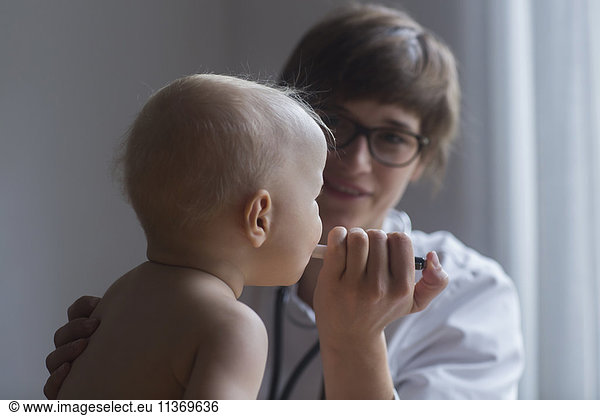 Paediatrician examining baby boy in clinic  Freiburg im Breisgau  Germany