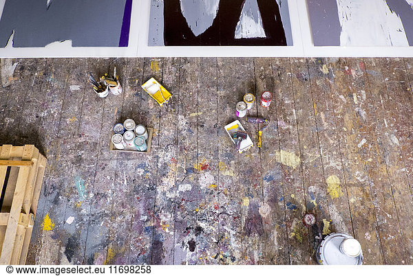 Paint supplies on floor of art studio