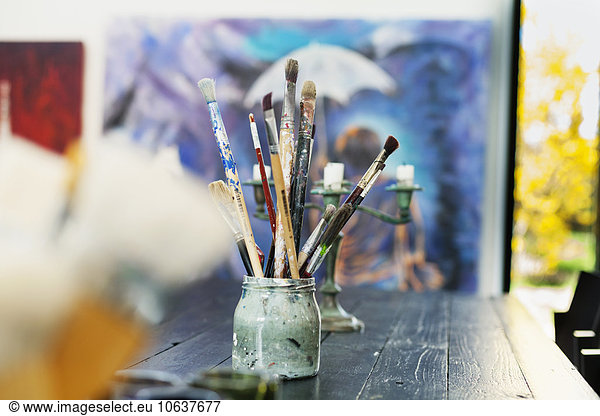 Paintbrushes in container on table at art studio