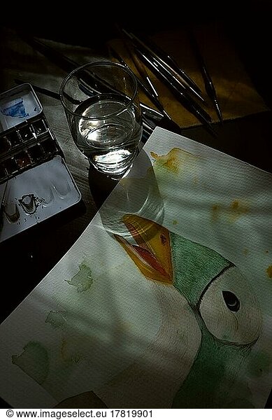 Painted goose  watercolour painting with water glass  brushes and watercolours