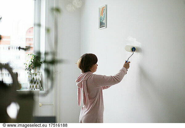 Painting the wall by a child.