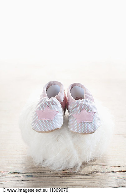 Pair of baby shoes on woolen soft ball