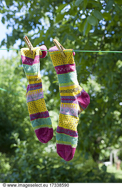 Pair of colorful socks drying on clothesline