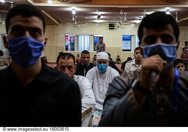 Palestinian Muslim listens to Imam while wearing a face mask as a precaution against COVID-19  during Eid Al-Fitr Festival following the reopening of mosques by local authorities and relaxation of some restrictions. Eid Al-Fitr marks the end of the holy fasting month of Ramadan  May 24  2020.