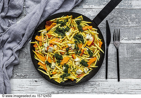 Pan of German schupfnudel with pumpkin kale and Gorgonzola cheese