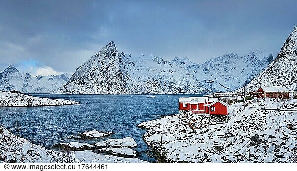 Panorama of Iconic Hamnoy fishing village on Lofoten Islands  Norway with red rorbu houses. With falling snow in winter