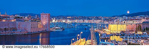 Panorama of Marseille Old Port and Fort Saint-Jean illumintaed in night with moon  Marseille  France  Horizontal camera pan