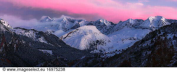 Panoramic of the valley at sunset with colorful clouds in mountains