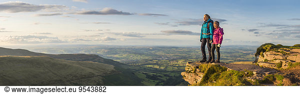 Panoramic view of hikers overlooking remote landscape