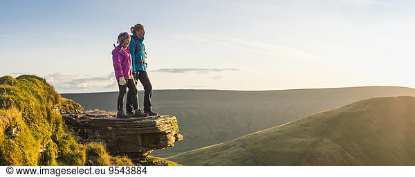 Panoramic view of hikers overlooking remote landscape